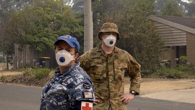 ADF personnel wear masks while working in Mallacoota. Getty Images