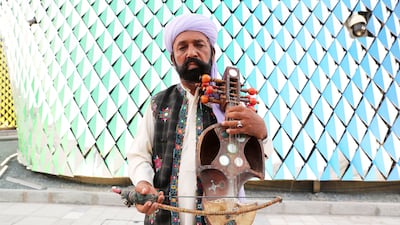 Mr Gul and his “band members” are part of the cultural team with the Balochistan government. Their musical instruments are hand-made and include ones that are similar to a fiddle and a drum. Pictured is another performer holding a suroz, which is considered as the national musical instrument of Balochistan. Pawan Singh / The National