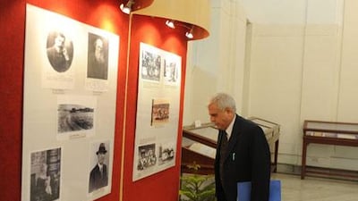 An Indian visitor looks at pictures of Mahatma Gandhi and other leaders during an exhibition at the national archive museum in New Delhi on Wednesday. A rare collection of letters between Mahatma Gandhi and a South African bodybuilder with whom he shared a close relationship went on display at the museum. Sajjad Hussain / AFP