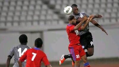 Makhete Diop, right, the Al Shaab forward, and his teammates, who beat Al Dhafra, in red, on Friday, will be in action again on Tuesday in the Etisalat Cup, where they face Dubai. Mike Young / The National