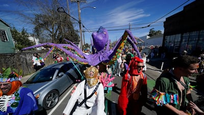 People march the Societe de Sainte Anne parade route during Mardi Gras on Tuesday in New Orleans. AP