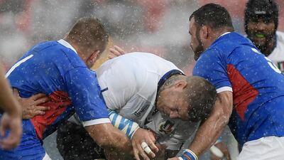 Italy prop Marco Riccioni, centre, attempts to run with the ball against Namibia at the Hanazono Rugby Stadium in Higashiosaka. AFP