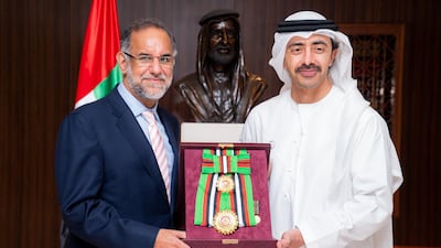 Sheikh Abdullah bin Zayed, Minister of Foreign Affairs and International Co-operation, presents the Order to the Navdeep Suri, outgoing Indian ambassador to the UAE, during a meeting at the ministry in Abu Dhabi on Monday. Wam