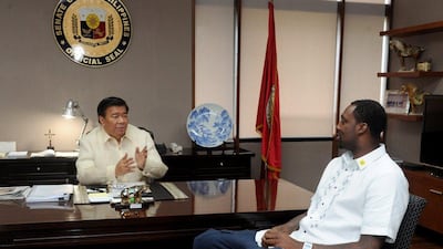 Philippine Senate president Franklin Drilon talks with NBA centre Andray Blatche. The American was granted citizenship by way of a special act of the Filipino government on Wednesday, June 11, 2014. Jay Directo / AFP