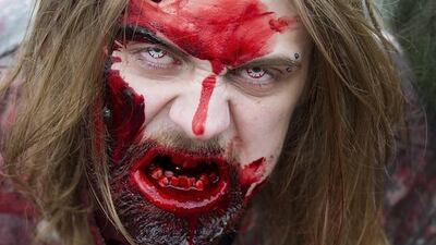 :A man dressed up as Zombie poses for a picture. Marco Secchi / Getty Images