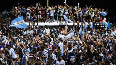 Fans gather outside the Argentinian Football Association headquarters awaiting the team bus to arrive. Reuters