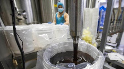 Date syrup pours out from one of the industrial machines at the factory.