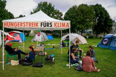 A hunger-striking climate activist has his blood pressure measured in a protest tent camp near the German Parliament in Berlin. AFP
