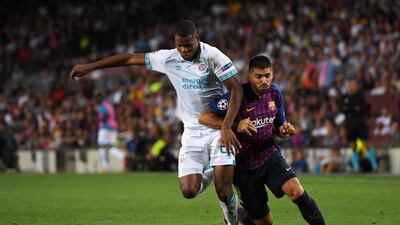 Barcelona's Luis Suarez battles for possession with PSV Eindhoven's Denzel Dumfries. Getty Images