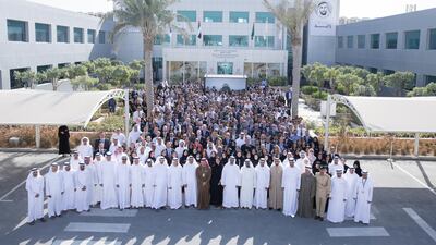 Sheikh Mohammed bin Zayed, Crown Prince of Abu Dhabi and Deputy Supreme Commander of the UAE Armed Forces (first row 8th R), stands for a group photo during a visit to the Expo 2020 main office in Jebel Ali. Hamad Al Mansoori for The Crown Prince Court