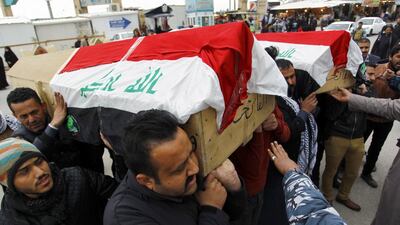 Mourners carry the coffins of victims of a car bomb in Baghdad's Bayaa neighbourhood the previous day during the funeral procession in the Shiite city of Najaf on February 17, 2017. Haidar Hamdani / AFP