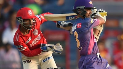 Kings XI Punjab's Wriddhiman Saha, left, looks on as Rising Pune Supergiant's Ajinkya Rahane plays a shot during their match at The Maharashtra Cricket Association Stadium in Pune on May 14, 2017. Rising Pune won the match by nine wickets. Indranil Mukherjee / AFP