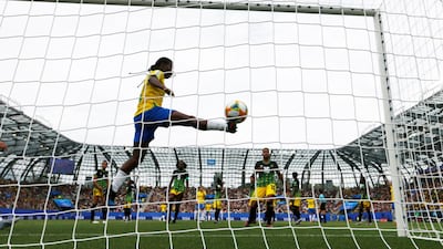 Brazil's Cristiane scores their third goal from a free kick to complete her hat-trick. Reuters