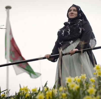 Hanan Issa with a Welsh flag flying overhead at Cardiff Castle while filming a clip with the youth media brand UmmahSonic in May 2017. Photo: Hanan Issa