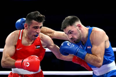 Jordan's Hussein Ishaish, left, lost out to Croatia's Gabrijel Veocic in the men's 80kg preliminaries. AFP