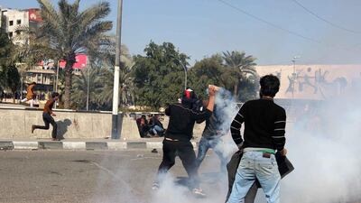 Protesters run from tear gas fired by security forces after supporters of the cleric Muqtada Al Sadr tried to approach the heavily fortified Green Zone during a protest at Tahrir Square in Baghdad on February 11, 2017. Mahmoud Raouf Mahmoud / Reuters