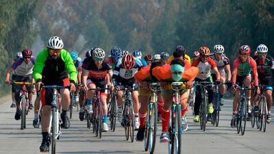 Men cycle during the contest for Peace Cup on the first day of reduction in violence between Afghan Government and Taliban. AFP