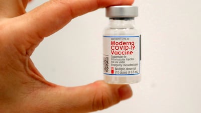 A health worker holds a vial of the Moderna Covid-19 vaccine at a pop-up in Manhattan, New York City. Reuters