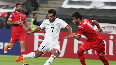 Al Jazira's Ali Mabkhout, left, and Shojae Khalilzadeh of Persepolis duel for the ball during their Asian Champions League game at Mohammed bin Zayaed Stadium in Abu Dhabi. Karim Sahib / AFP