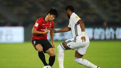 Yuki Muto of Urawa Red Diamond is challenged by Fares Juma of Al-Jazira during the FIFA Club World Cup match between Al Jazira and Urawa Red Diamonds at Zayed Sports City Stadium on December 9, 2017 in Abu Dhabi, United Arab Emirates. (Photo by Francois Nel/Getty Images )