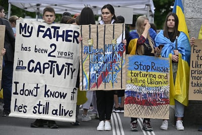 People attend a standing peace rally for the Ukraine Peace Conference organised by the Ukrainian Society in Switzerland and family members of Ukrainian prisoners of war in Lucerne, Switzerland. EPA