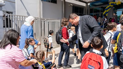 Regent International School principal David Williams welcomes pupils at the gates. Photo: Fortes Education
