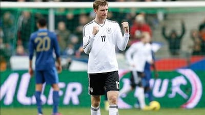 Germany defender Per Mertesacker celebrates his team's winning goal against France.