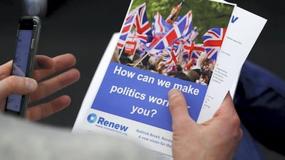 A journalist reads literature produced by the Renew party at press conference in London, Britain, February 19, 2018. REUTERS/Peter Nicholls - RC1AB6ED3390