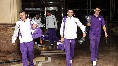 Al Ain players including Elias Rebeiro, left, and Valetin Badea, right, arrive at Hangzhou airport yesterday.