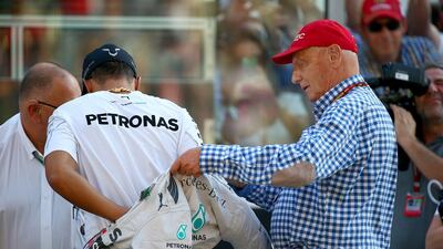 Niki Lauda, non-executive chairman of Mercedes-GP, spends some time with Lewis Hamilton before the Abu Dhabi Grand Prix on Sunday. Mark Thompson / Getty Images
