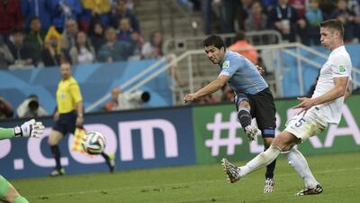 Luis Suarez shoots and scores the winner against England on Thursday in Uruguay's 2-1 victory in World Cup Group D play in Sao Paulo, Brazil. Daniel Garcia / AFP