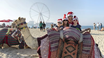 Matt and Lori Hubbard with Olivia, eight, Gage, 10, and a festive camel on Christmas Day 2017. Christopher Pike / The National