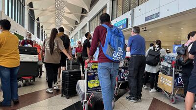 Passengers at the Terminal 1 departure area at the Dubai International Airport in Dubai.