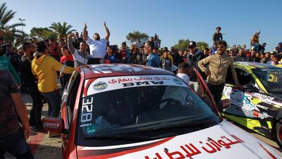 Spectators cheer a Libyan driver at a drifting competition meeting in the coastal city of Benghazi, Libya. AFP