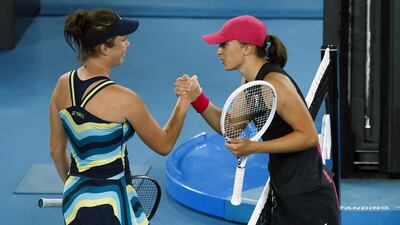 Linda Noskova, left, shakes hands with Iga Swiatek after knocking the world No 1 out of the Australian Open. AFP