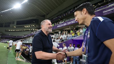 Al Nassr coach Ange Postecoglo, left, shakes hands with his Al Ain counterpart Vladimir Ivic. Chris Whiteoak / The National
