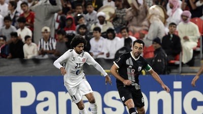 Al Sadd’s Xavi plays the ball against Yaqoub Yousif of Al Jazira in their Asian Champions League match in Abu Dhabi. Jeffrey E Biteng / The National