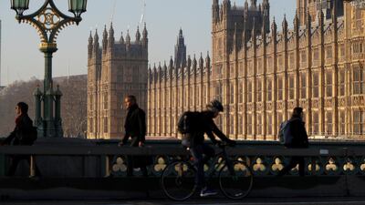 Commuters cross Westminster bridge in London. Reuters.