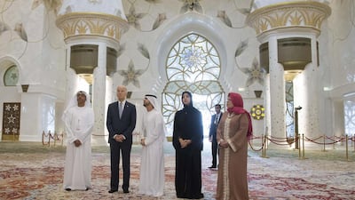 Joe Biden visted the Sheikh Zayed Grand Mosque earlier in the day. With him are Yusef Al Obaidly, Director General of the Sheikh Zayed Grand Mosque Centre, left, Ishaq Mohammed Al Mushairi, tour guide, third right, Reem Ibrahim Al Hashemi, Minister of State for International Cooperation, second right, and Barbara Leaf, US ambassador to the UAE, right. Razan Al Zayani for Crown Prince Court - Abu Dhabi