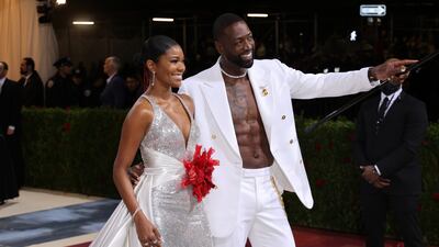 Gabrielle Union and Dwayne Wade, shirtless in a white suit on the red carpet. EPA