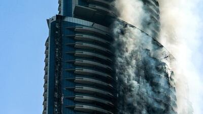The Address Downtown Dubai smoulders on New Year’s Day this year after catching fire the night before. Victor Besa for The National