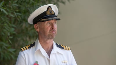 Commander Mark Stuttard, a British Royal Navy Liaison Officer, pays his respects at the service in Sharjah. Ruel Pableo for The National