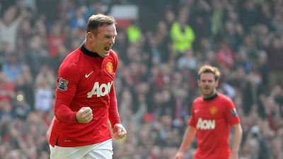 Manchester United's Wayne Rooney, left, celebrates after scoring his team's second goal against Aston Villa during their English Premier League match at Old Trafford on March 29, 2014. Martin Rickett / AP Photo