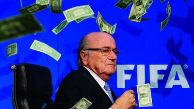The now banned Fifa president Sepp Blatter is showered by fake dollar bills during a press conference at the FIFA headquarters on July 20, 2015 in Zurich, Switzerland. Philipp Schmidli / Getty Images