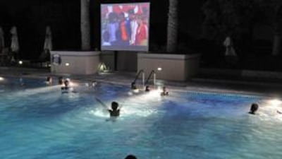Kids enjoy the pool and watch a movie at Cine-Splash at the Dubai Polo and Equestrian Club.