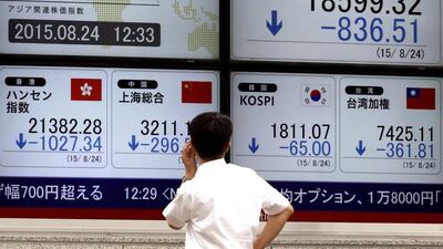 A Japanese investor monitors Asian stocks at an electronic board in Tokyo. Kimimasa Mayama / EPA