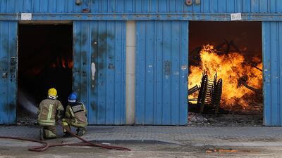 SHARJAH , UNITED ARAB EMIRATES - JUNE 26 : Major fire broke out in the warehouse area in Sharjah Industrial area close to the National Paints in Sharjah. ( Pawan Singh / The National ) For News. Story by Nawal Al Ramahi