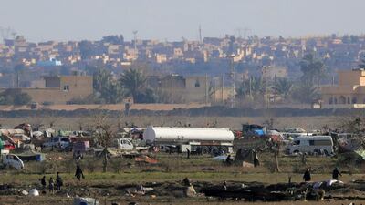 ISIS members walk in their final holdout of Baghouz, Syria February 18, 2019. Reuters