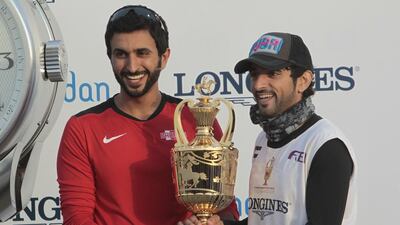 Sheikh Nasser bin Hamad Al Khalifa of Bahrain presents the trophy to Sheikh Hamdan after his win.