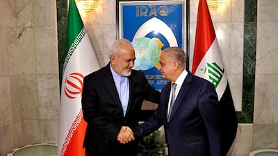 Fomer Iraqi foreign minister Mohamed Al Hakim, right, shakes hands with his visiting Iranian counterpart Mohammad Javad Zarif at the Ministry of Foreign Affairs Building in Baghdad, Iraq, Sunday, March 10, 2019. AP